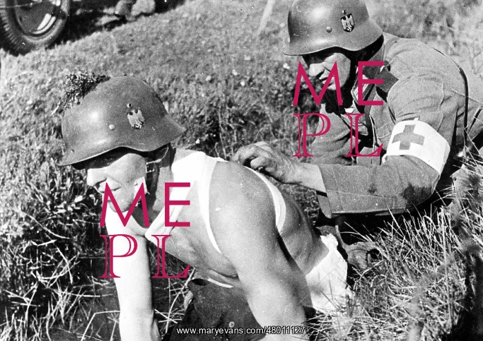 : Medic helps a wounded man : Medic helps a wounded man