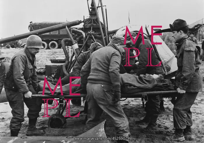 : Medics carry a wounded U.S. soldier away from : Medics carry a wounded U.S. soldier away from