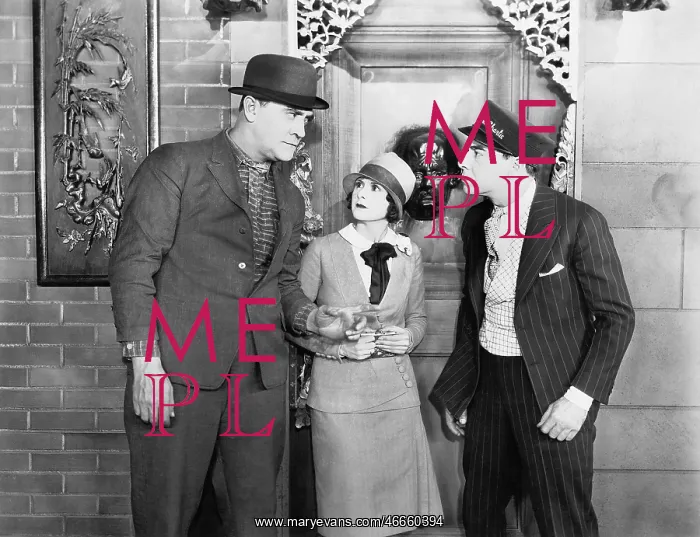  : Two men in an argument with a woman in the middle