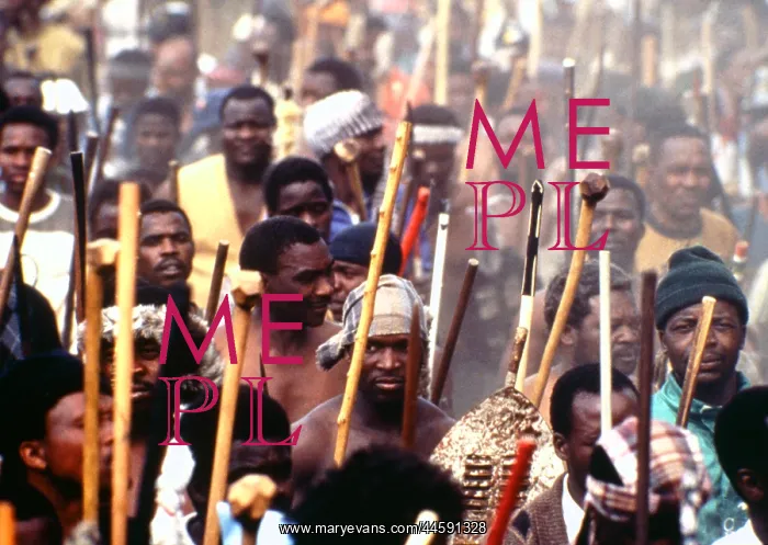 : Men, armed with traditional weapons, march though : Men, armed with traditional weapons, march though