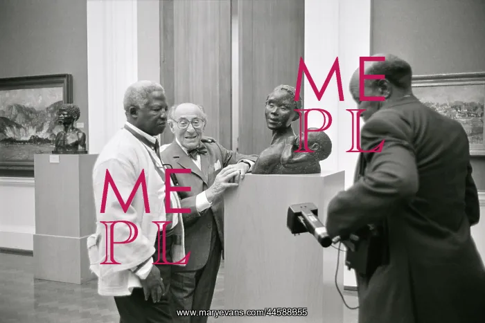 : Three men in an art gallery stand around the statue : Three men in an art gallery stand around the statue