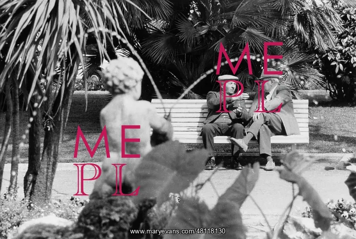 : Two men chatting on a park bench : Two men chatting on a park bench