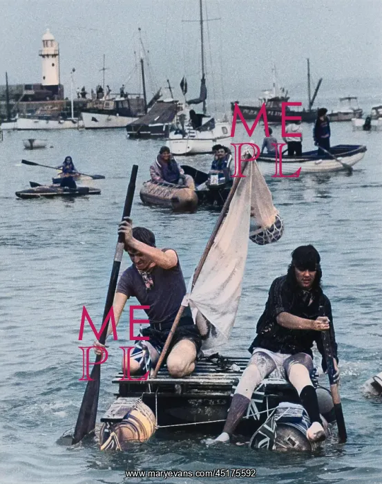 : Two men competing in a raft race, St Ives, Cornwall : Two men competing in a raft race, St Ives, Cornwall