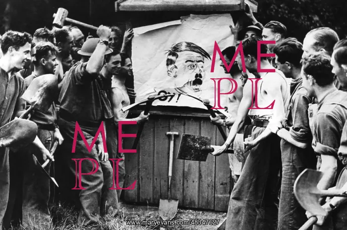 : Men destroy a Hitler illustration, 1939 : Men destroy a Hitler illustration, 1939