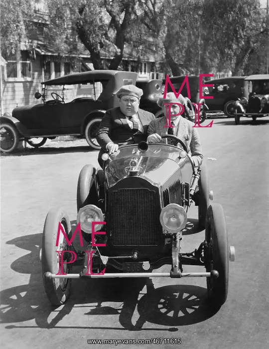 : Two men driving a veteran car : Two men driving a veteran car