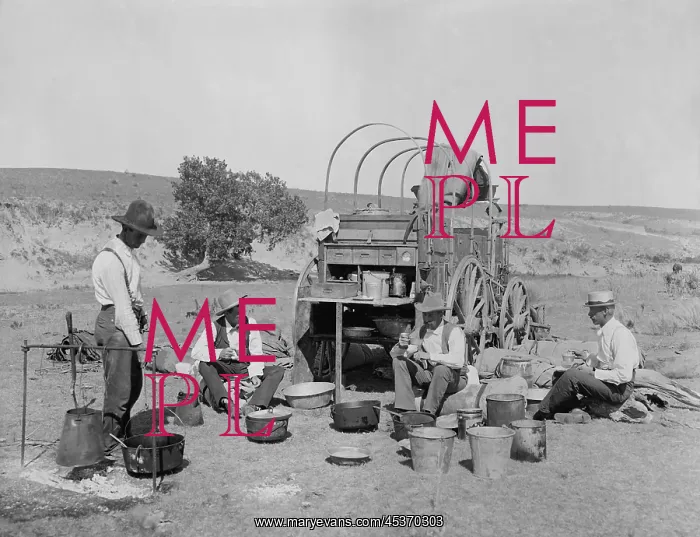 : Four men eating at a chuck wagon on a Texas : Four men eating at a chuck wagon on a Texas