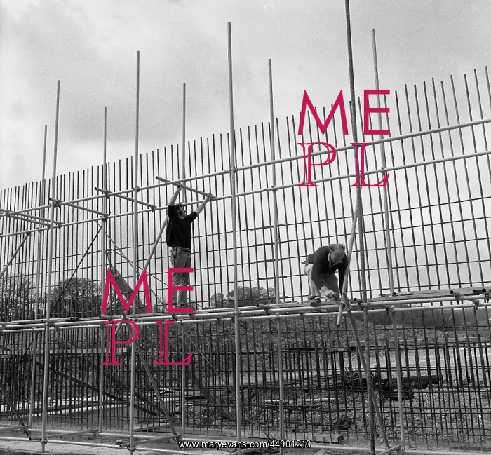 : Two men erecting scaffolding : Two men erecting scaffolding