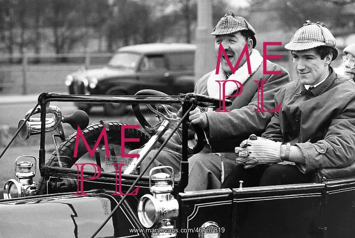 : Two men having fun in a vintage car : Two men having fun in a vintage car