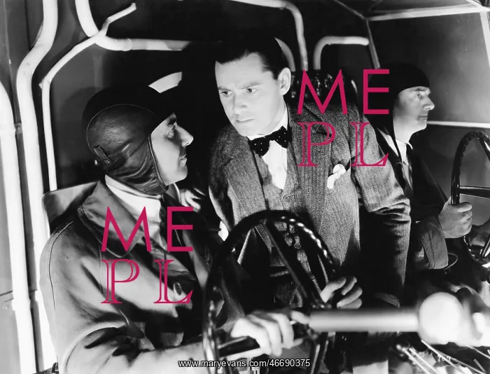  : Three men inside of the cockpit of an airplane