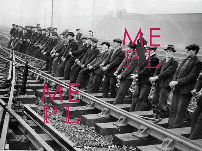 : Men levers new railway lines into : Men levers new railway lines into