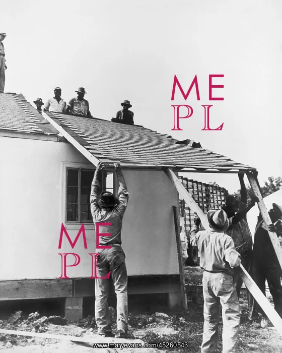 : Men lifting a section of roof, prefabs, USA : Men lifting a section of roof, prefabs, USA