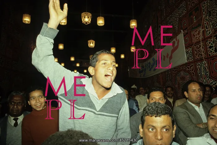 : Men listening to a speech at a rally for ? : Men listening to a speech at a rally for ?