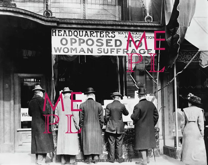 : Men looking at material posted in the window of : Men looking at material posted in the window of