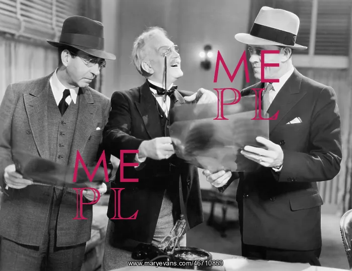 : Three men looking at x-rays : Three men looking at x-rays