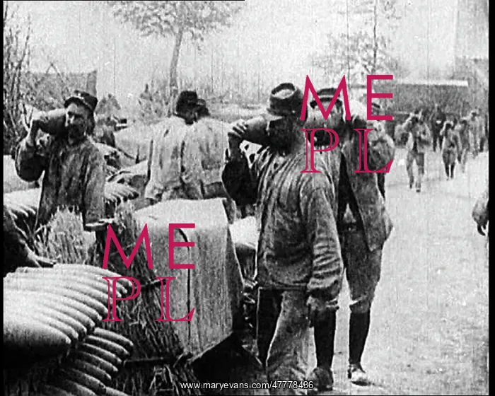 : Men Moving Small Artillery Shells Onto Large Stockpiles : Men Moving Small Artillery Shells Onto Large Stockpiles