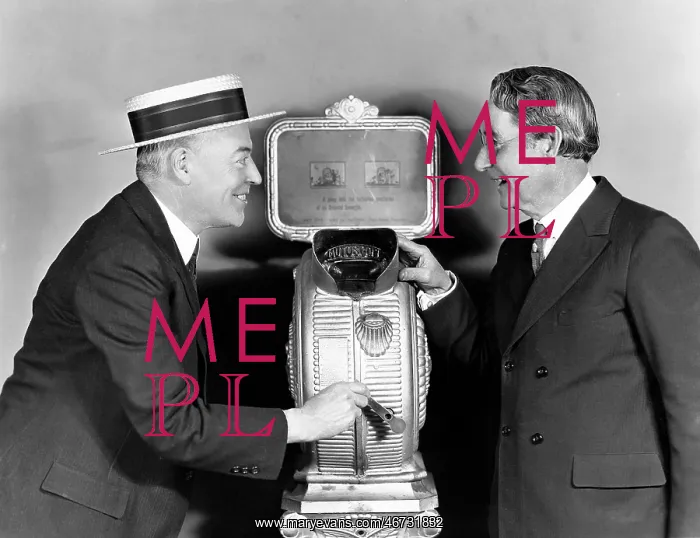 : Two men next to a nickelodeon : Two men next to a nickelodeon