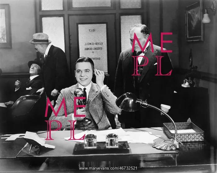 : Men at an office one on the telephone : Men at an office one on the telephone