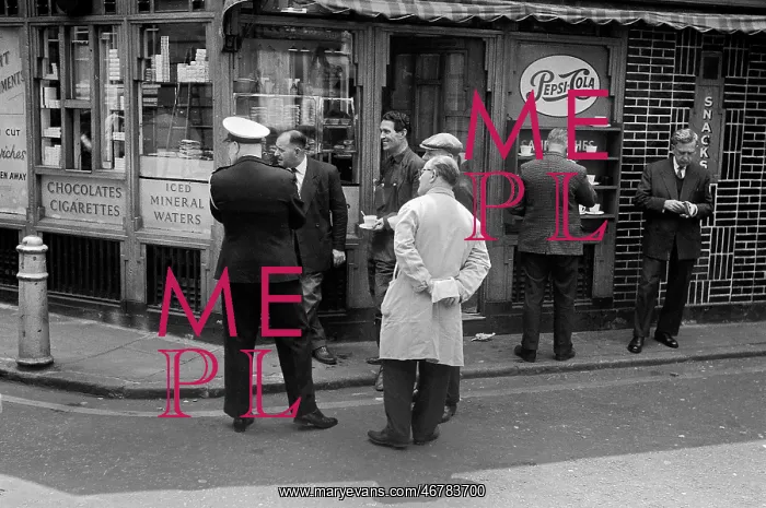 : Men outside a snack bar see something amusing : Men outside a snack bar see something amusing