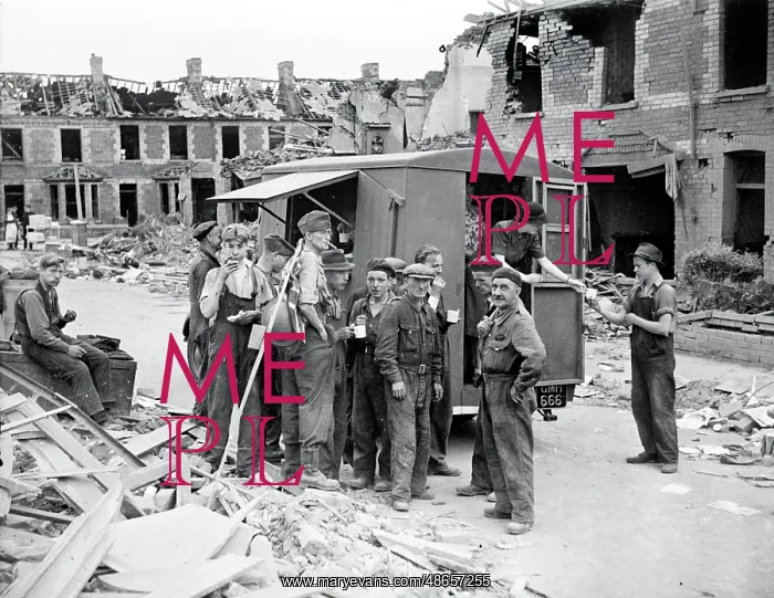 : Men outside a tea van on a bomb damaged street : Men outside a tea van on a bomb damaged street