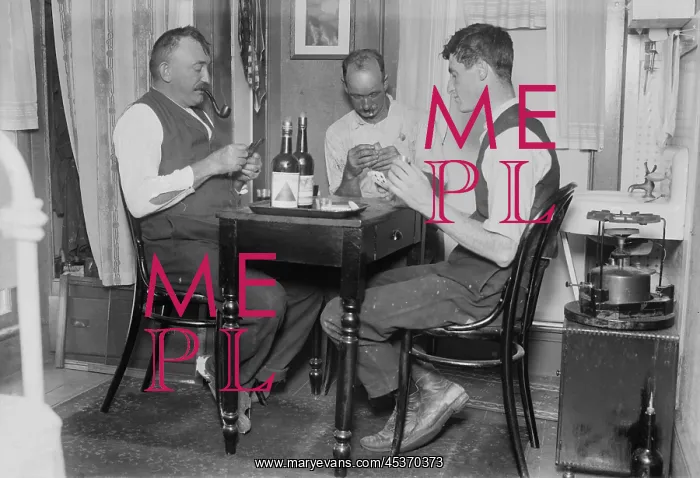 : Two men playing cards in a home in Broad Channel : Two men playing cards in a home in Broad Channel