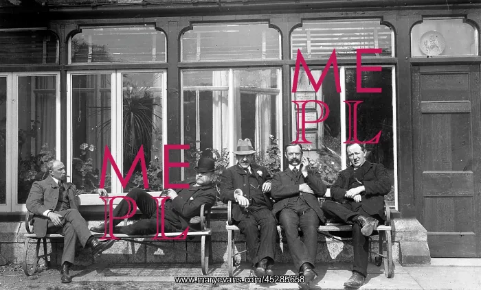 : Five men relaxing on a bench : Five men relaxing on a bench