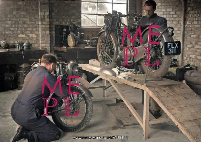 : Two men repairing motorcycles : Two men repairing motorcycles