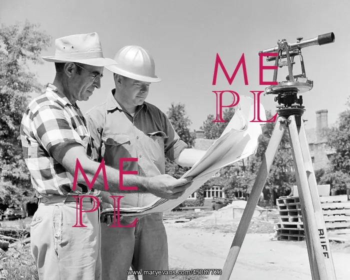 : Men Reviewing Building Plans Standing on Construction Site : Men Reviewing Building Plans Standing on Construction Site