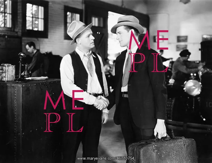  : Two men shaking hands in a car shop