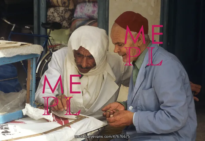 : Two men sit beside stall in the market at Houmt Souk, Djerba : Two men sit beside stall in the market at Houmt Souk, Djerba