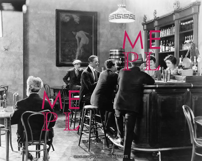 : Men sitting around a counter in a bar : Men sitting around a counter in a bar