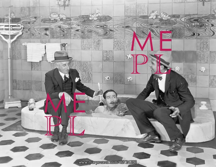: Two men sitting at the edge of a bathtub in suits : Two men sitting at the edge of a bathtub in suits