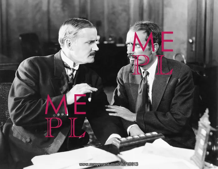 : Two men sitting together talking : Two men sitting together talking