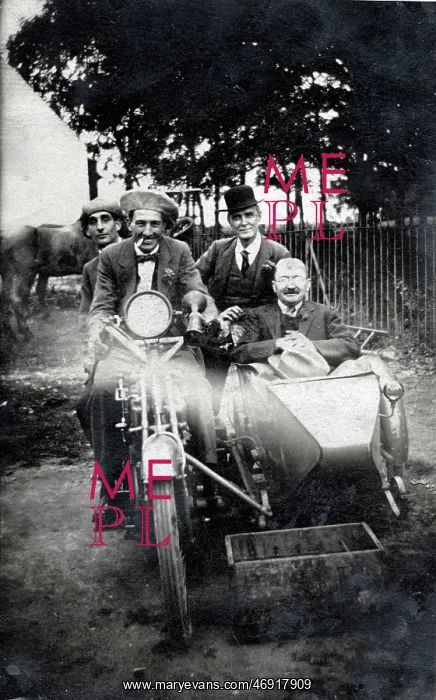 : Four men sitting on vintage motorcycle and in sidecar : Four men sitting on vintage motorcycle and in sidecar