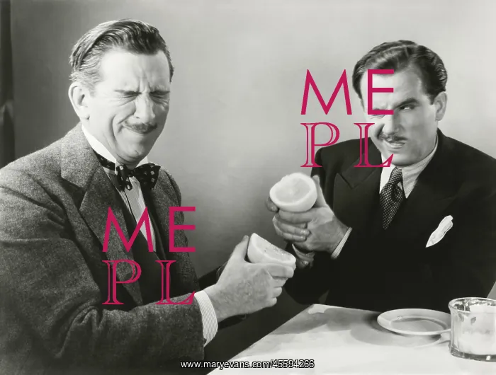 : Two men squirting grapefruit juice at each other - : Two men squirting grapefruit juice at each other -