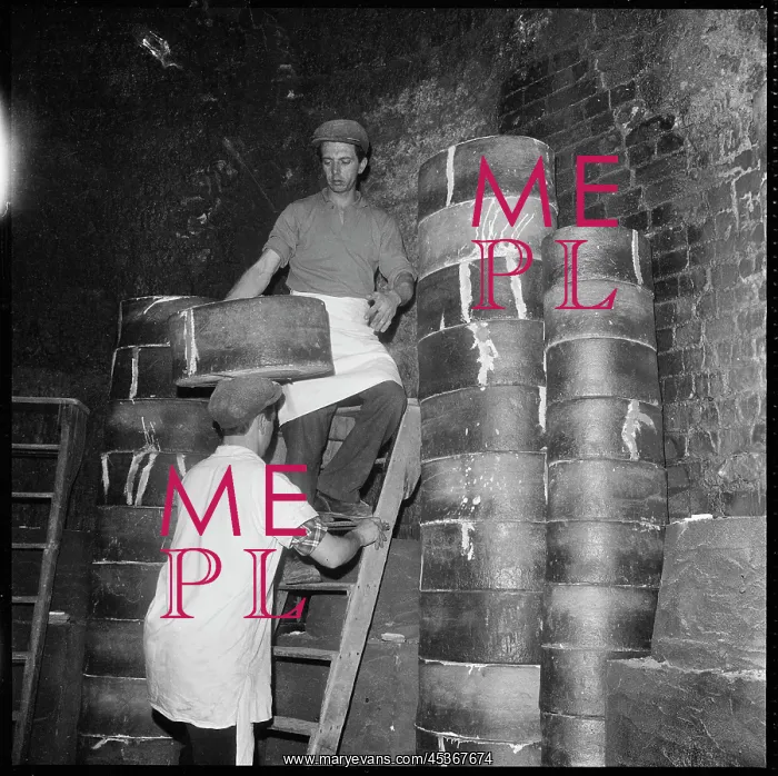 : Two men stacking saggars containing ceramics : Two men stacking saggars containing ceramics