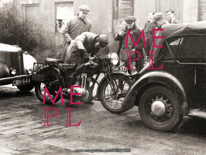 : Men standing around an Ariel motorcycle : Men standing around an Ariel motorcycle