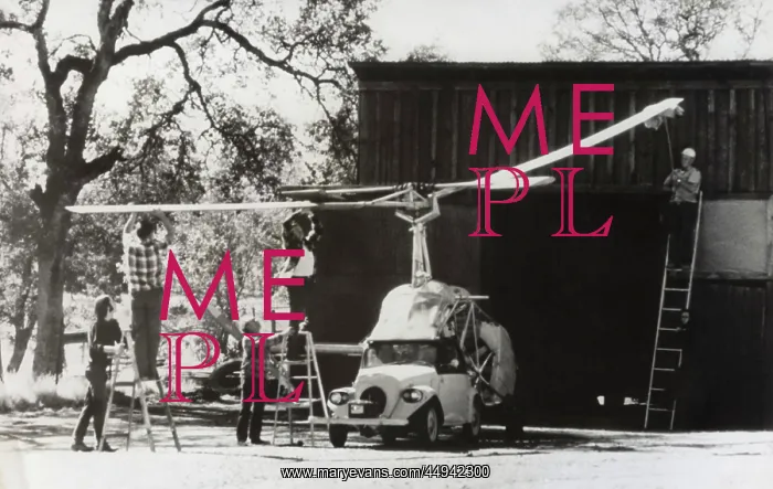 : Men Standing on Ladders Attaching the Rotors Onto a Heli? : Men Standing on Ladders Attaching the Rotors Onto a Heli?