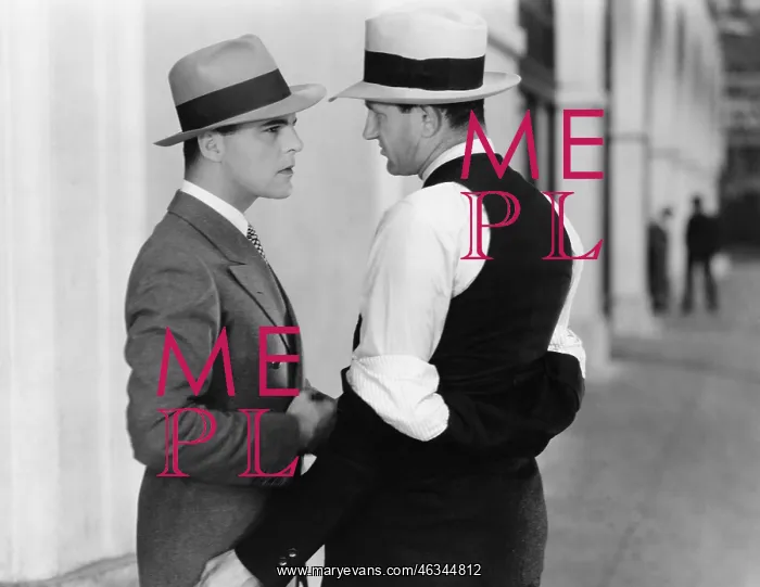 : Two men standing together talking : Two men standing together talking