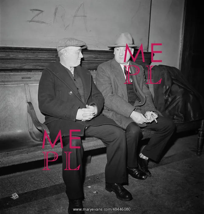 : Men talking on bench while waiting for next : Men talking on bench while waiting for next