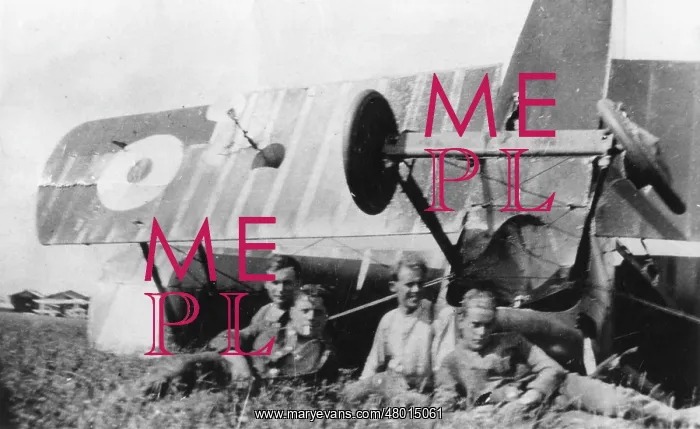: Four men with upturned biplane in field, WW1 : Four men with upturned biplane in field, WW1
