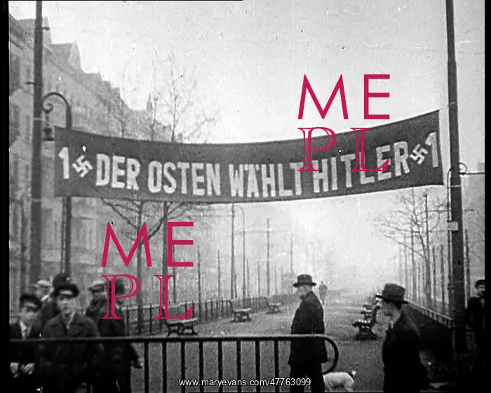 : Men Walking Below Banner Reading - 1 Der Osten : Men Walking Below Banner Reading - 1 Der Osten