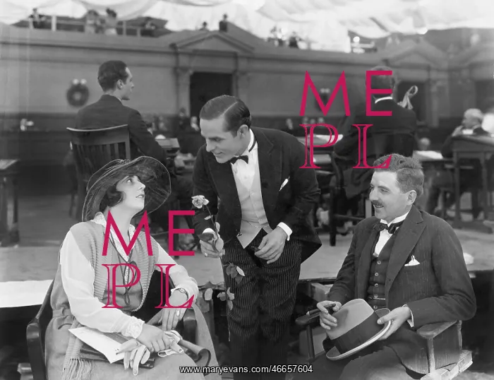 : Two men and a woman in a restaurant on the pier : Two men and a woman in a restaurant on the pier