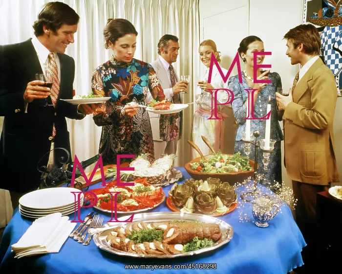 : Men and Women Around a Party Buffet Table Talking : Men and Women Around a Party Buffet Table Talking