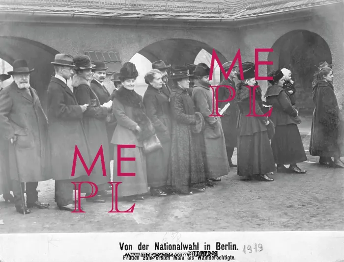 : Men and women are standing in line in front : Men and women are standing in line in front