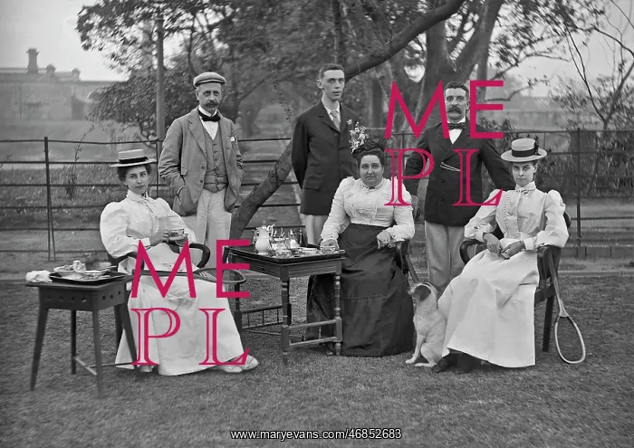: Men and women taking tea in a garden : Men and women taking tea in a garden