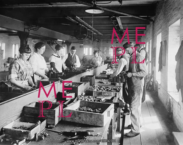 : Men and Women working on an assembly line in the : Men and Women working on an assembly line in the