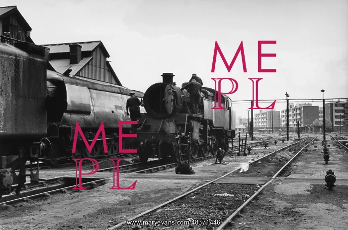 : Men working on steam engine at Nine Elms Loco Yard : Men working on steam engine at Nine Elms Loco Yard