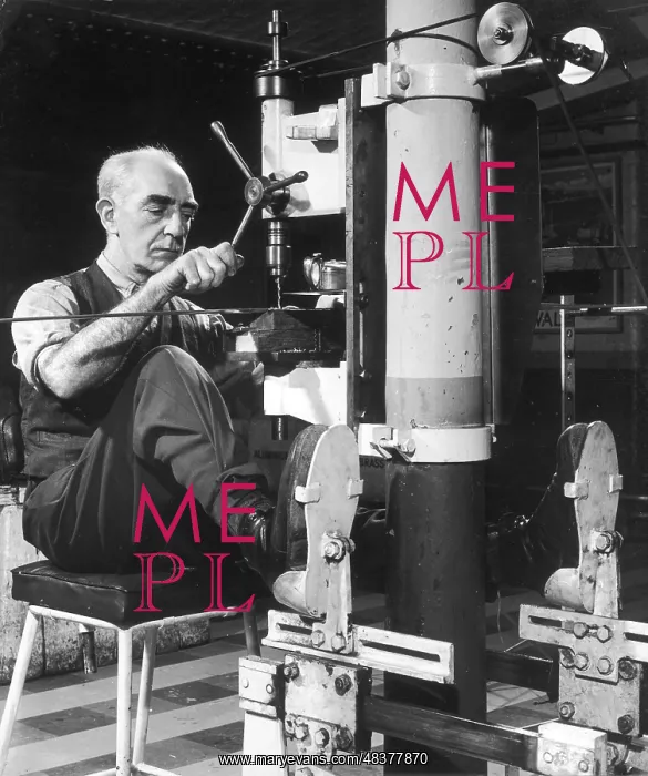 : A metalworker operating a drill : A metalworker operating a drill