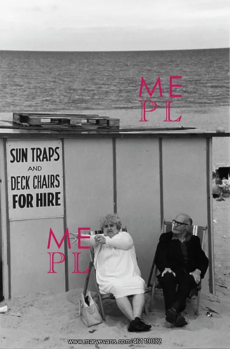 : Middle-aged couple on deckchairs at the seaside : Middle-aged couple on deckchairs at the seaside