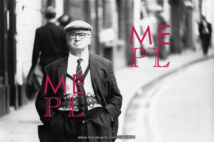 : Middle-aged man walking down a street : Middle-aged man walking down a street